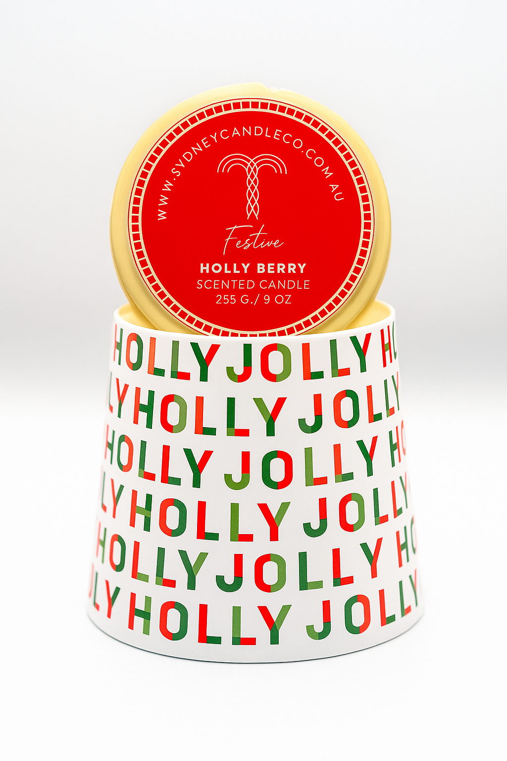 Holly Jolly scented candle with a red lid on a white background