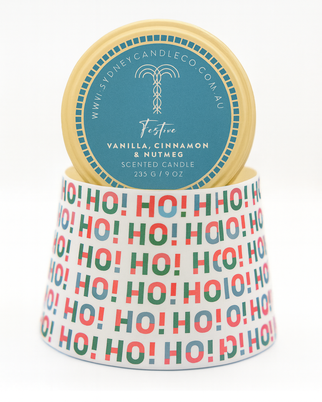 Scented candle with 'Ho Ho Ho' pattern and vanilla, cinnamon, nutmeg description
