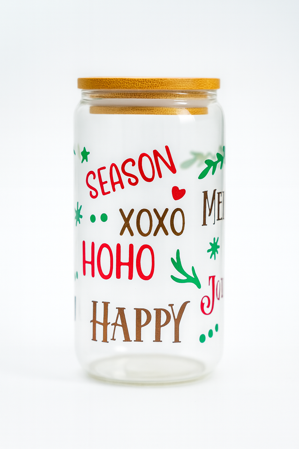 Decorative glass jar with Christmas-themed text and designs on a white background